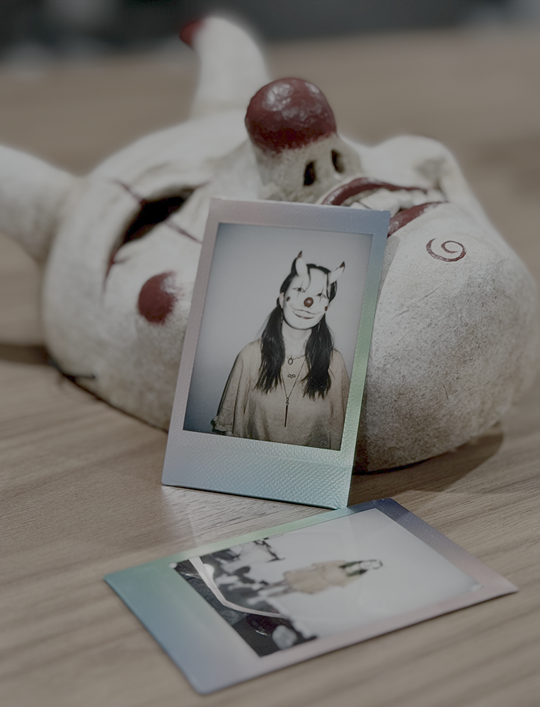 Sculpture of a mask with photos of me wearing it.